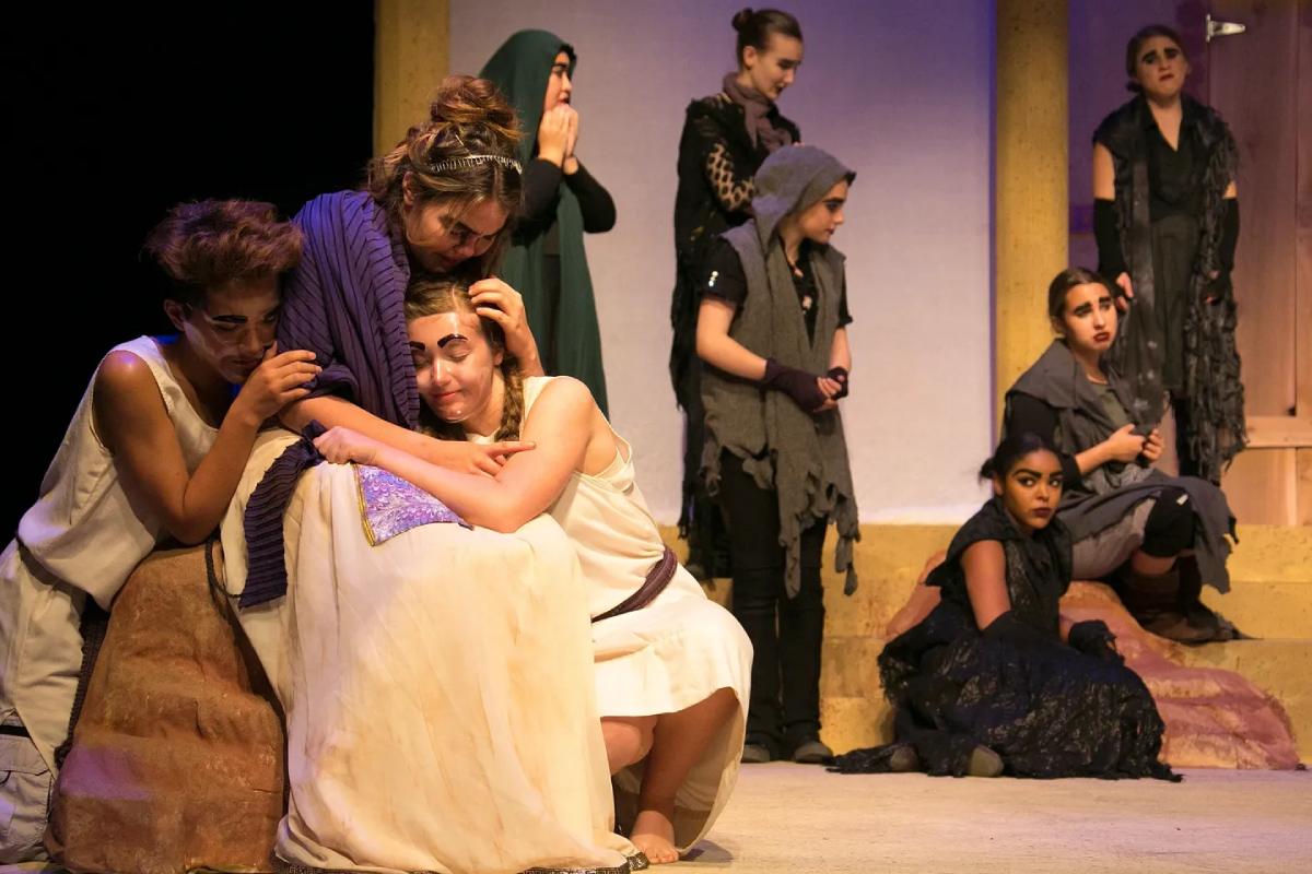 A picture of the young woman playing a skit on the stage